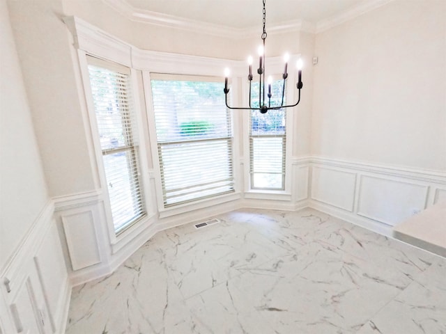 unfurnished dining area featuring an inviting chandelier and crown molding