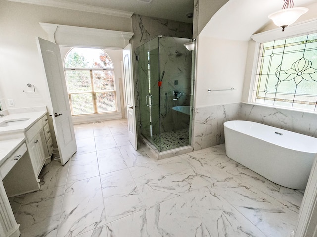 bathroom with vanity, ornamental molding, and separate shower and tub