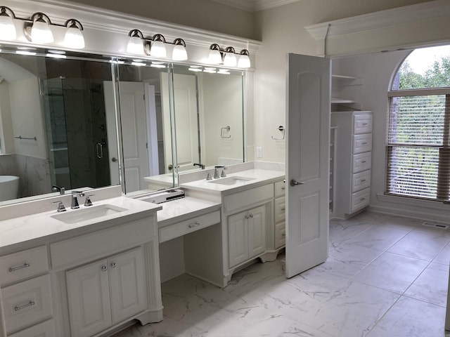 bathroom with vanity, crown molding, and walk in shower