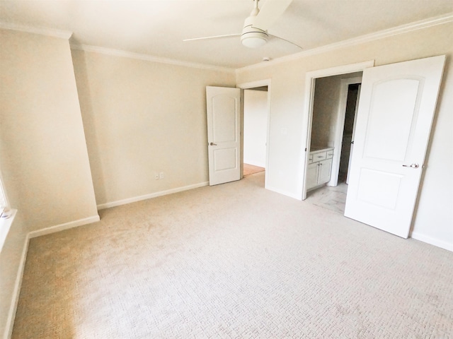 unfurnished bedroom featuring crown molding, ceiling fan, ensuite bathroom, and light carpet