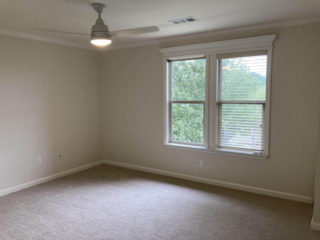 carpeted spare room featuring crown molding and ceiling fan