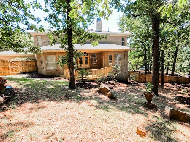 rear view of property featuring a deck