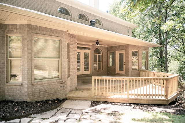 doorway to property with ceiling fan and a deck