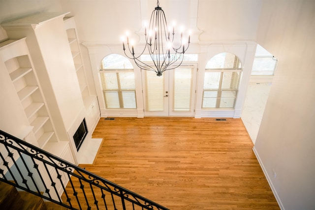 unfurnished dining area featuring light hardwood / wood-style flooring and a notable chandelier