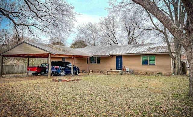 ranch-style home with a front lawn and a carport