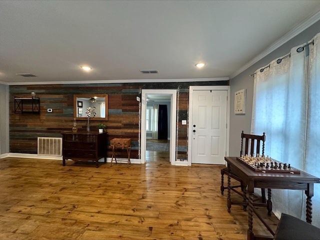 entryway featuring hardwood / wood-style floors and crown molding