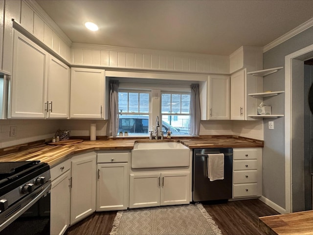 kitchen with stainless steel appliances, white cabinetry, sink, and wooden counters