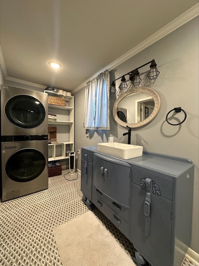 laundry area with stacked washer / dryer, ornamental molding, and sink