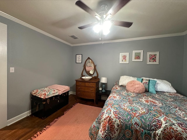 bedroom featuring ceiling fan, ornamental molding, and dark hardwood / wood-style flooring