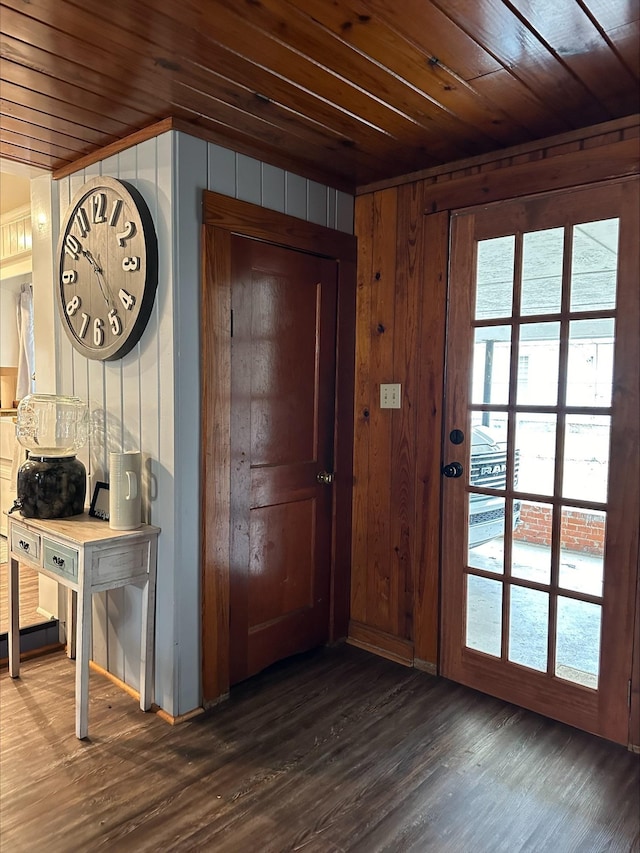 entryway featuring wood ceiling, dark wood-type flooring, and wood walls