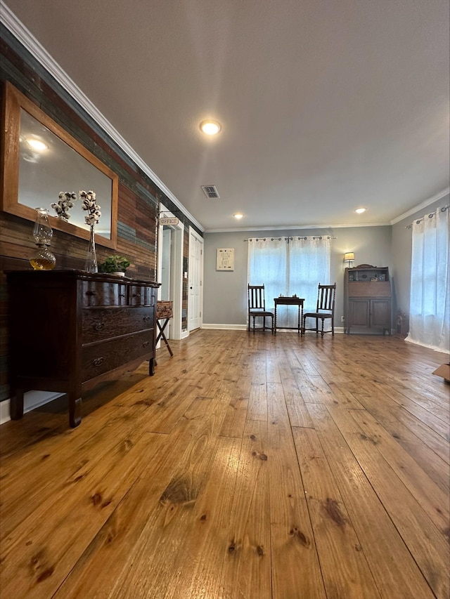 interior space with hardwood / wood-style flooring and crown molding