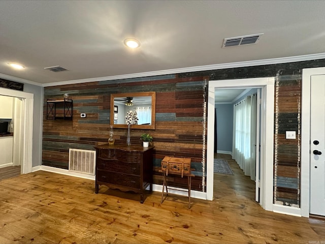 bar with ornamental molding and hardwood / wood-style floors