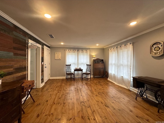 sitting room featuring crown molding and hardwood / wood-style floors