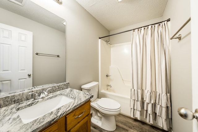 full bathroom with shower / bathtub combination with curtain, vanity, toilet, and a textured ceiling