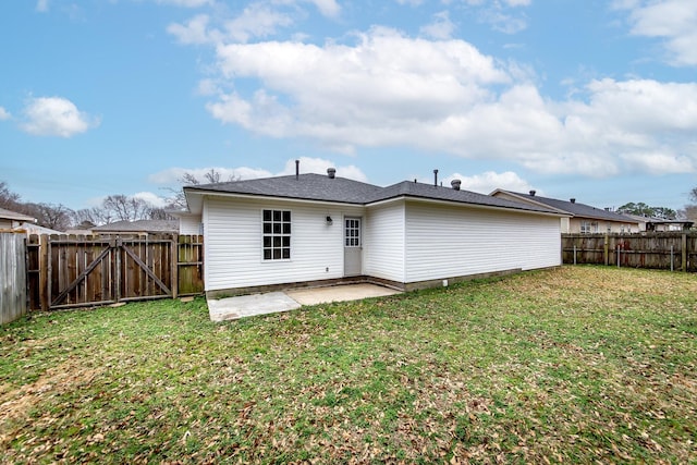 back of property with a yard and a patio area