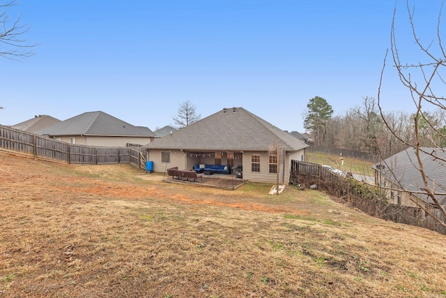 back of house with a yard and outdoor lounge area