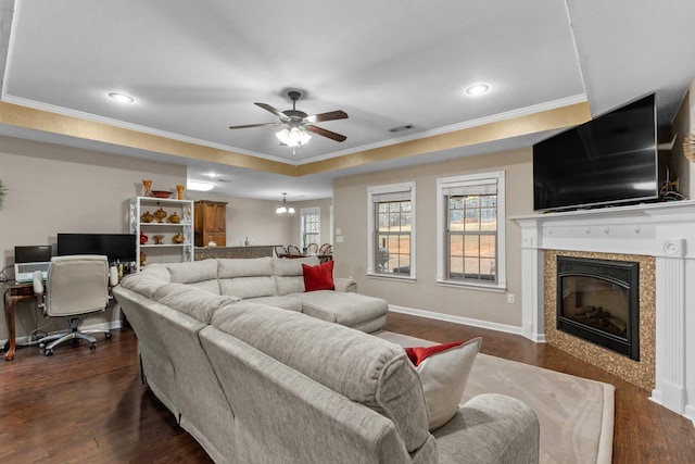 living room featuring crown molding, dark wood-type flooring, and ceiling fan