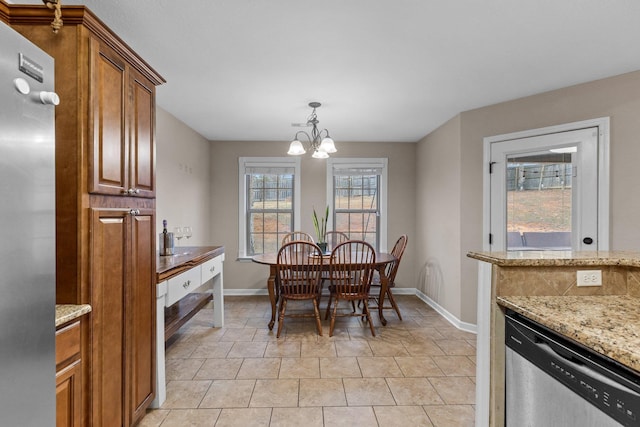 dining space with light tile patterned flooring and a notable chandelier