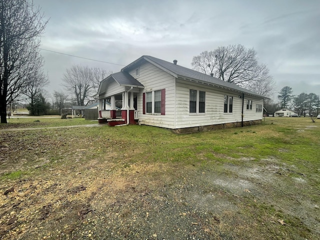 view of side of home featuring a lawn