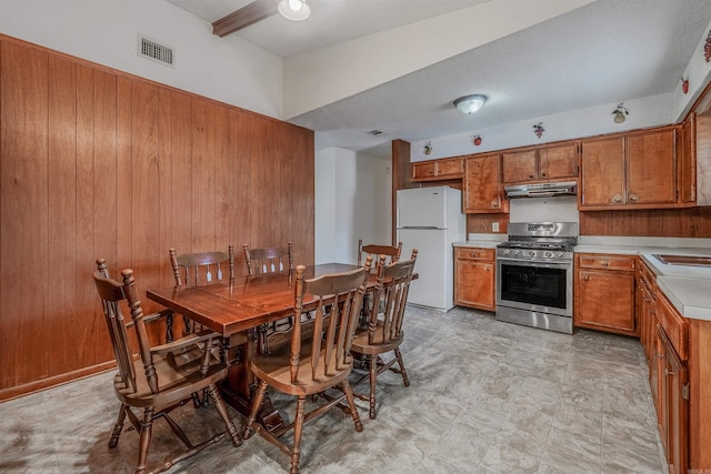 dining room with sink and wooden walls