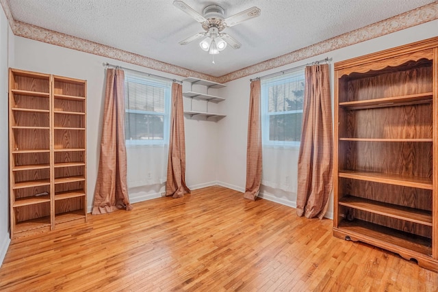 unfurnished bedroom featuring ceiling fan, light hardwood / wood-style floors, and a textured ceiling