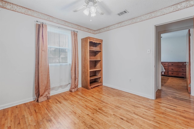 unfurnished bedroom featuring ceiling fan and light hardwood / wood-style floors