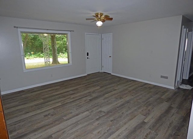 spare room with ceiling fan and dark hardwood / wood-style flooring