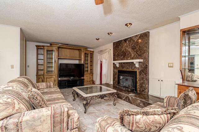 living room with ornamental molding, a textured ceiling, and a fireplace