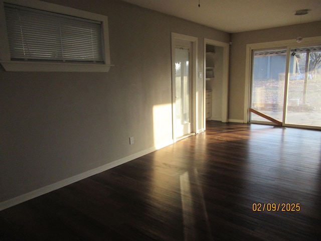 spare room with wood-type flooring