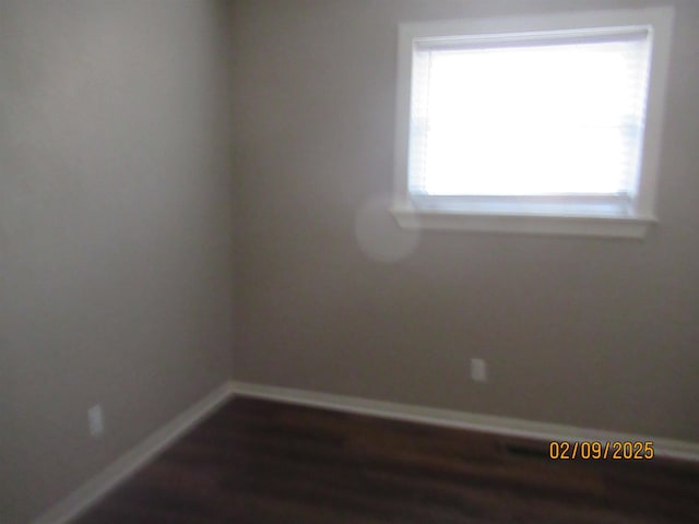 empty room with dark wood-type flooring