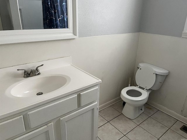 bathroom featuring tile patterned floors, vanity, and toilet