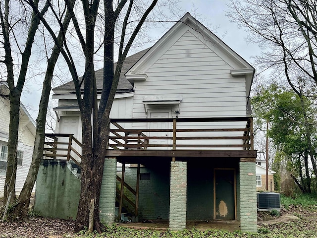 rear view of house featuring cooling unit and a deck