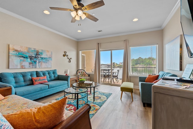 living room with crown molding, ceiling fan, and light hardwood / wood-style floors