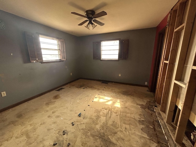 spare room featuring plenty of natural light and ceiling fan