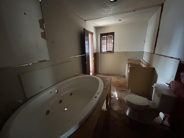 bathroom featuring a washtub and toilet