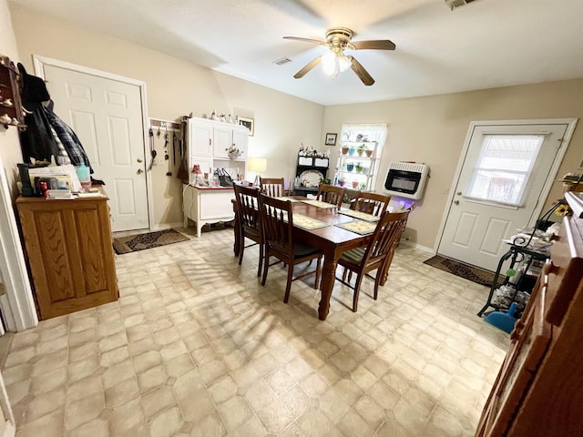 dining room featuring heating unit and ceiling fan