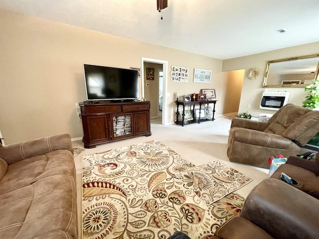 living room with heating unit and light carpet