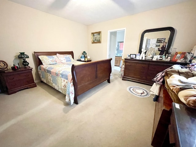 bedroom featuring light carpet and ensuite bath