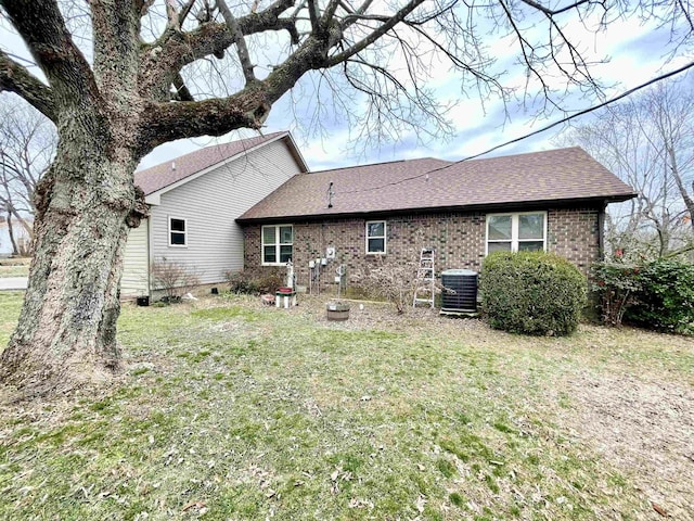 back of house featuring a yard and central AC