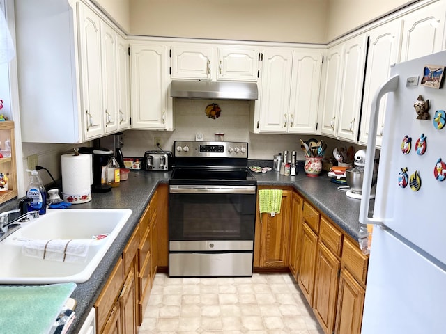 kitchen with white cabinetry, stainless steel electric range oven, and white refrigerator