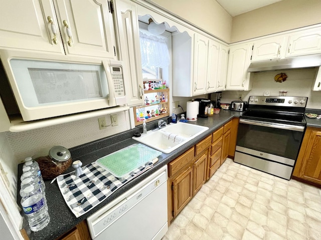 kitchen featuring white appliances, sink, and white cabinets