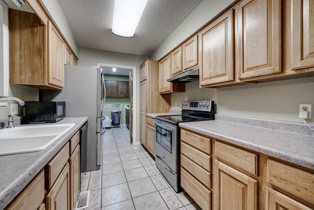 kitchen featuring sink, light tile patterned floors, electric range, a textured ceiling, and light brown cabinets