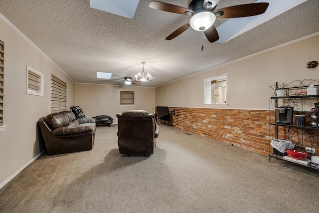 living room with brick wall, ornamental molding, carpet floors, and a textured ceiling