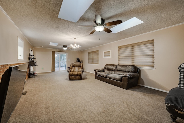 carpeted living room featuring crown molding, a skylight, ceiling fan with notable chandelier, and a textured ceiling