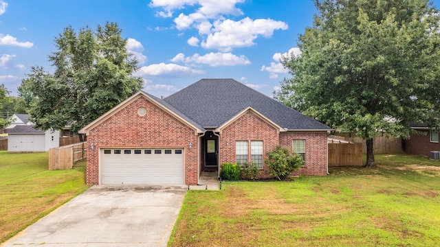 view of front of home featuring a garage, central air condition unit, and a front lawn