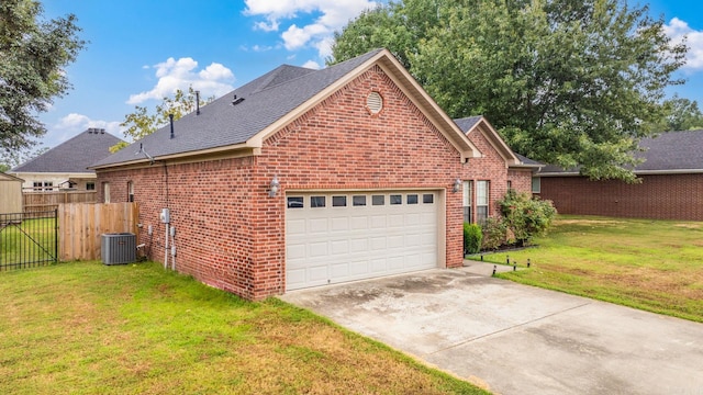 exterior space with a garage, central AC, and a lawn