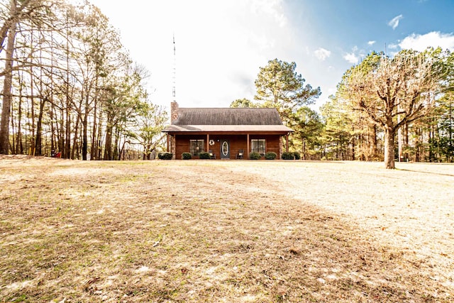 log cabin featuring a front lawn