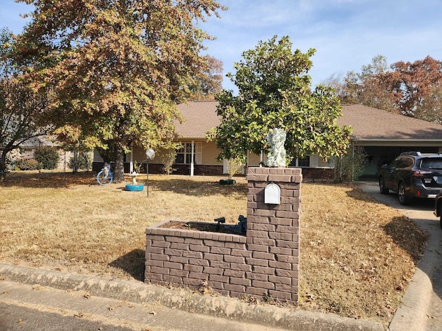 view of front of house with a garage and a front lawn