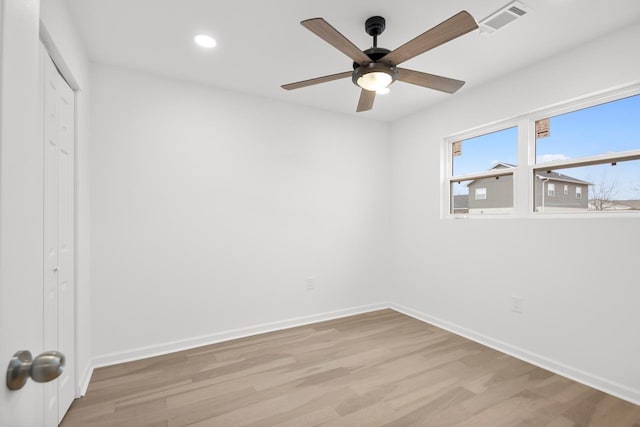 empty room with light hardwood / wood-style flooring and ceiling fan