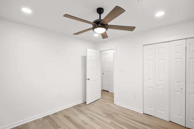 unfurnished bedroom with ceiling fan, a closet, and light wood-type flooring